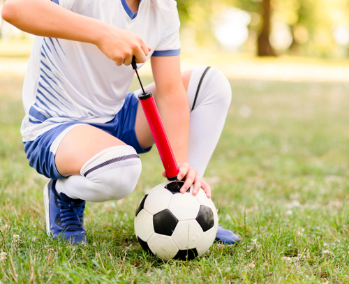 soccer player inflate soccer ball