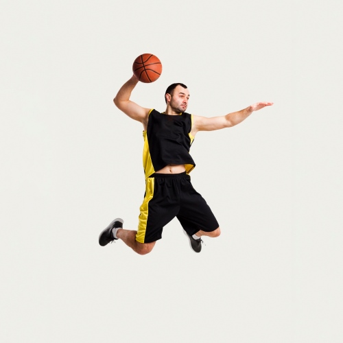front-view-male-player-posing-mid-air-while-throwing-basketball
