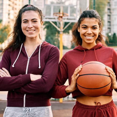 women posing together with basketball