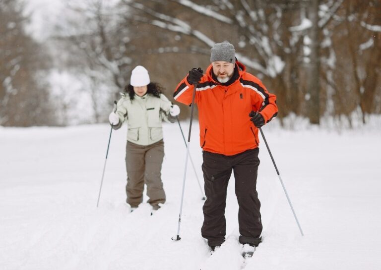 Bulgaria couple in winter park People activewear trekking in the forest