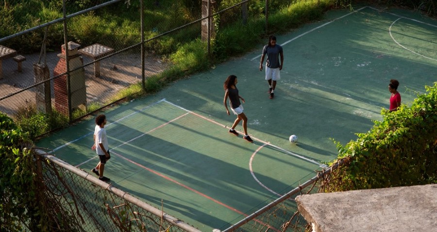 friends playing football in small ground